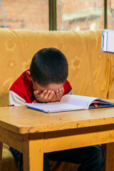vertical photo latino child frustrated by schoolwork - concept of frustration