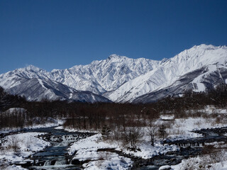 Fototapeta premium 冬の白馬村 冠雪した北アルプス、五竜岳と松川