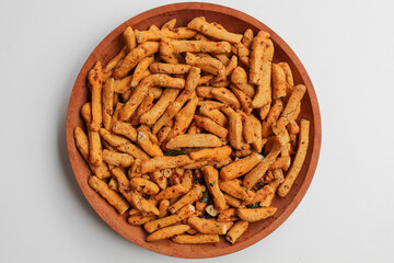 Basreng or bakso goreng, snack from sliced and fried meatballs, isolated on white background. On wooden plate, flat lay or top view