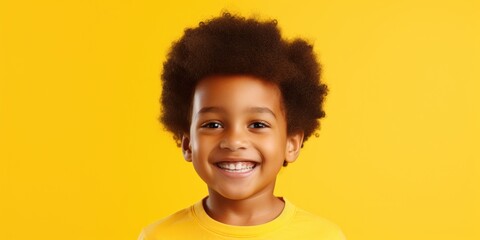 A young boy with an afro smiling at the camera. Suitable for various projects