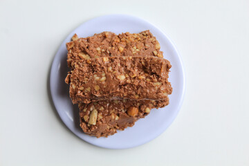 Three bars of chocolate mixed with crushed nuts, isolated on white background