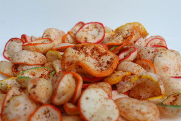 Kerupuk seblak, is colorful round crackers with spicy chili powder topping, isolated on white background