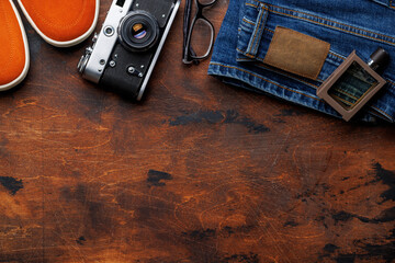 Men's Clothing on wooden Background: Jeans, Sneakers, Eyeglasses - 755403272