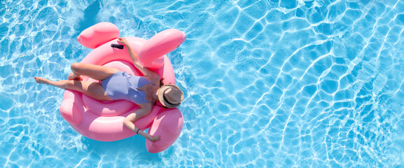 Woman in Bikini on Inflatable Flamingo in Pool - 755405423