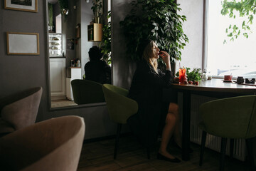 Woman Sitting at Table With Strawberry Drink