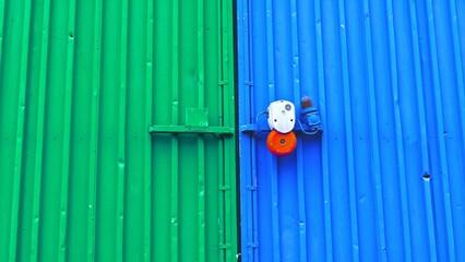 Blue and Green Warehouse Hangar Door with Red Alarm Bell