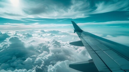 View across plane wing, flying over cloudy skies
