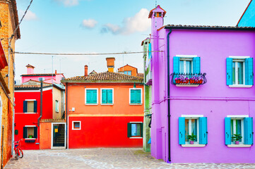 Colorful architecture in Burano island, Venice, Italy. Lavender and red painted houses.