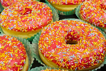 A high angle shot with donuts with sprinkles