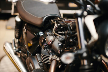 Fototapeta na wymiar Wires and pipes inside motorcycle in garage of biker