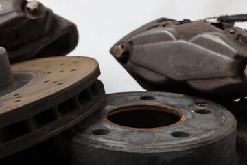 Old rusty brake disc on white background. Auto service industry. Spare parts catalog.