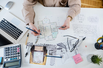 Caucasian young female architect working with home drawing plan  with architect equipment