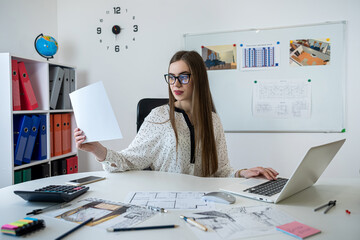 Caucasian young female architect working with home drawing plan  with architect equipment
