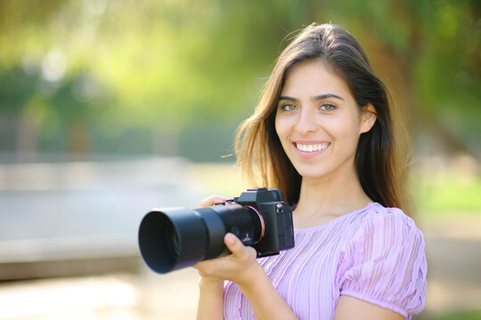 Happy photographer posing looking at camera