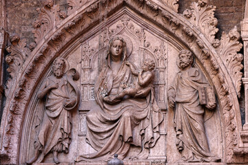 Bas-relief of the Virgin Mary with Jesus on the wall of a house in the San Marco district of Venice. Italy