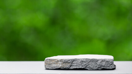 Podium with green forest blur background
