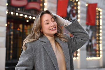 Portrait of smiling woman on city street in winter