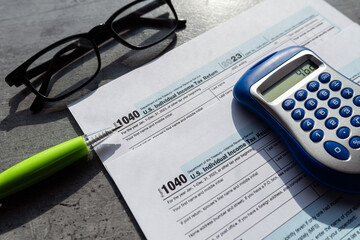 Time to pay taxes concept 1040 tax form pem glasses calculator