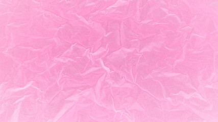 Pink background of a wrinkled paper. Wrinkled or crumpled pink paper texture. Abstract rough background. Close-up bright pink color background.
