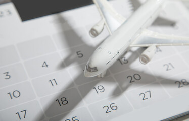 Toy airplane on calendar. Travel