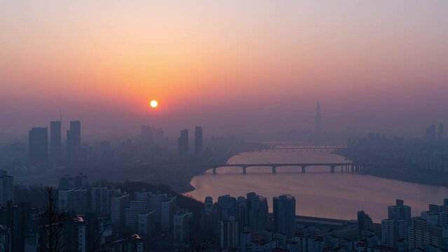 Sunrise of city buildings along the Han River seen from Maebongsan Park at dawn in Seoul, South Korea
