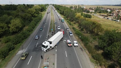 The truck and the car collided on the highway. Strong accident. Traffic accidents on the road. View from above. Traffic jam on the road. 