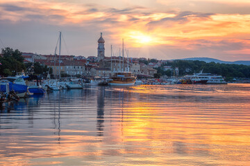 Scenic view of Krk, the town on the Krk island, Kvarner bay, Croatia. Beautiful cityscape with medieval architecture, harbor with yachts and rising sun, Adriatic seacoast, outdoor travel background - 755451690
