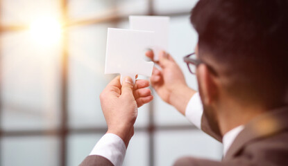 Businessman trying to connect puzzle pieces closeup