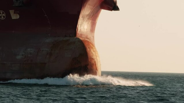 Large cargo ship sailing on the sea. bow of the ship, Bulb close-up. Logistics import export, shipping or transportation