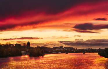 Dramatic stunning red sky at sunset, a romantic scenery over the Neckar river in Heidelberg, Germany 
