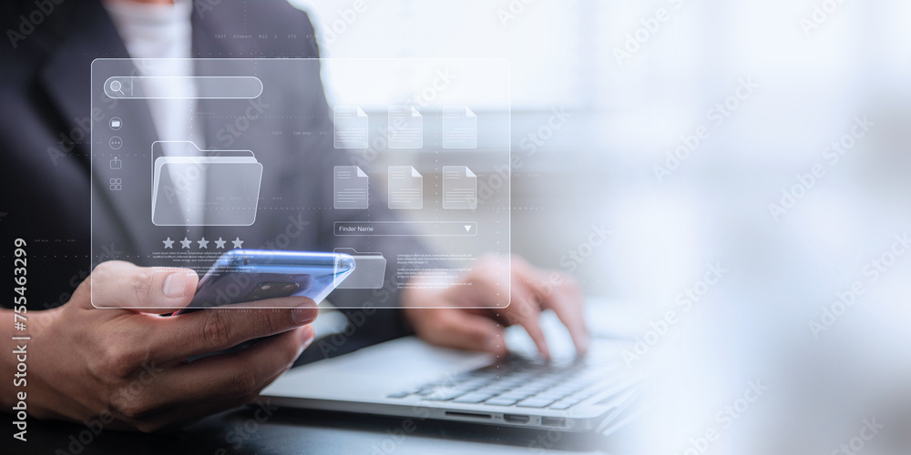 Poster document management system concept, businessman using a laptop computer and smartphone at the office