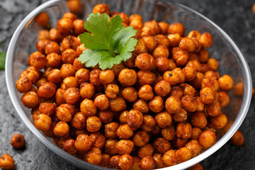 Roasted spicy chickpeas in bowl. Healthy snack.