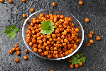 Roasted spicy chickpeas in bowl. Healthy snack.