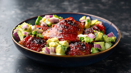 Lemon and tomato paste glazed Mediterranean style chicken thighs served with avocado and cucumber...