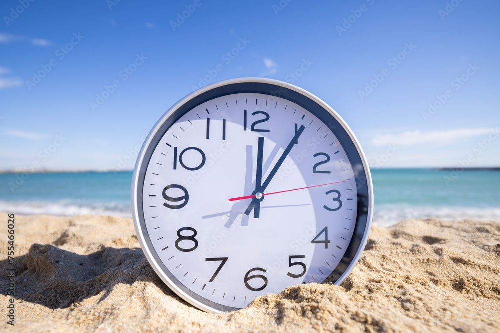 Poster clock with time passing on a beach