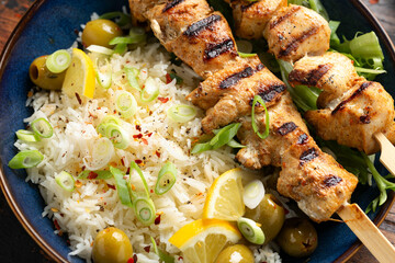Greek grilled chicken skewers served with lemon rice and marinated green olives
