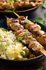 Greek grilled chicken skewers served with lemon rice and marinated green olives