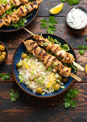 Greek grilled chicken skewers served with lemon rice and marinated green olives