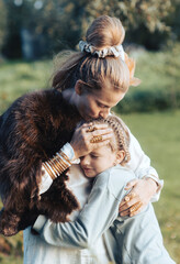 Young loving mother hugging her daughter, mom demonstrating unconditional love for child