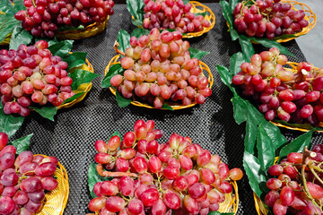 Fresh red grapes fruit in basket at the market