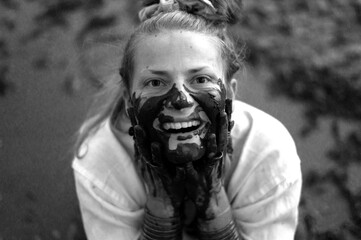 Happy woman with dirty black hands near face, joyful emotions