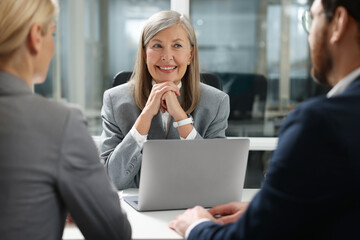 Lawyer working with clients at table in office