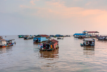Fototapeta na wymiar Village on the water of Tonle Sap lake in Cambodia. Beautiful lighting, sunset.