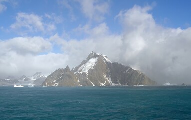 approaching the mountain peaks, icebergs,  and glaciers of elephant island,  on the antarctic...