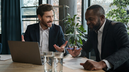 Caucasian businessman insurance agent consult African American male client advise financial offers...