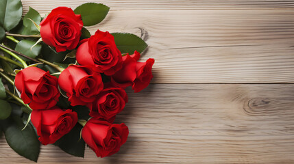 A bouquet of red roses on a light wooden background  