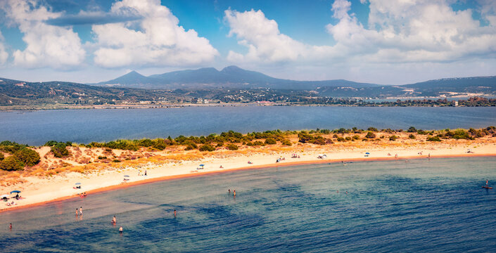 Vacation concept background. A lots of tourist sunbathe and swim on the Voidokilia Beach. Beautiful ігььук seascpae of Ionian sea, Pilos town location, Peloponnese peninsula, Greece, Europe.