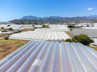 Panoramic drone view of vast landscape of greenhouses in Manavgat, Antalya, Turkey . Greenhouses for year-round cultivation of vegetables in Dembra Turkey. Concept of growing vegetables in greenhouses