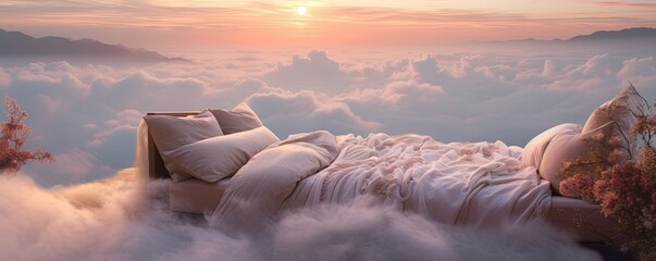 As the sun rises, a bed sits atop a sea of clouds, covered in blankets and pillows, creating a dreamy and serene outdoor landscape