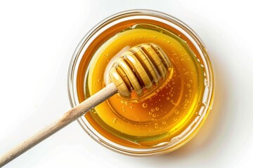 A spoonful of honey is sitting in a bowl with a wooden spoon. The honey is thick and golden. The bowl is on a white background